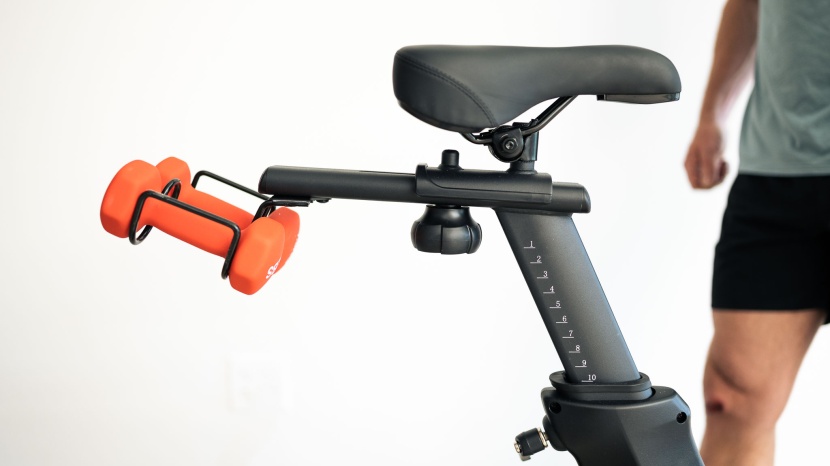 exercise bike - easy-to-reach dumbbells let you engage your upper body while you...