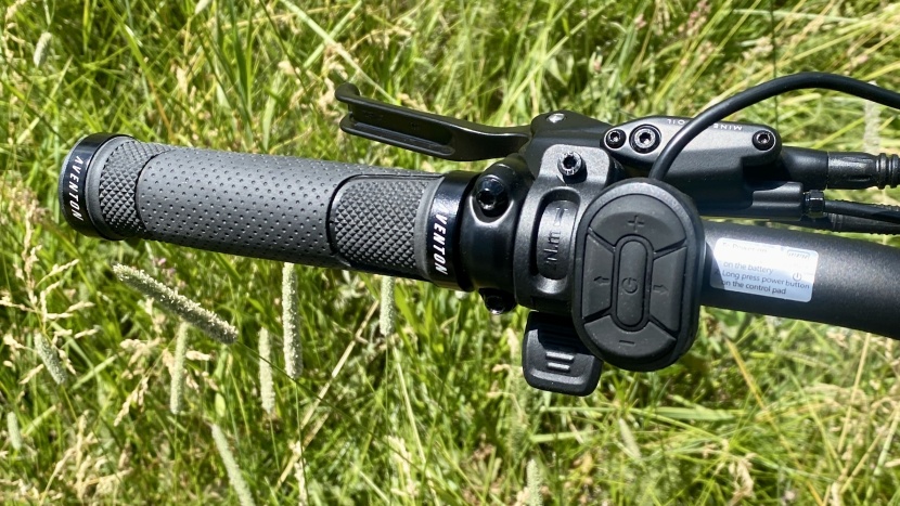 aventon aventure.2 step-through - the remote is clearly shown with its 5 button design and the thumb...