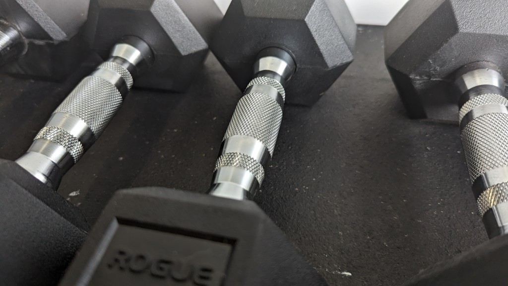 dumbbells - a closeup of the knurling on the rogue highlights the little...