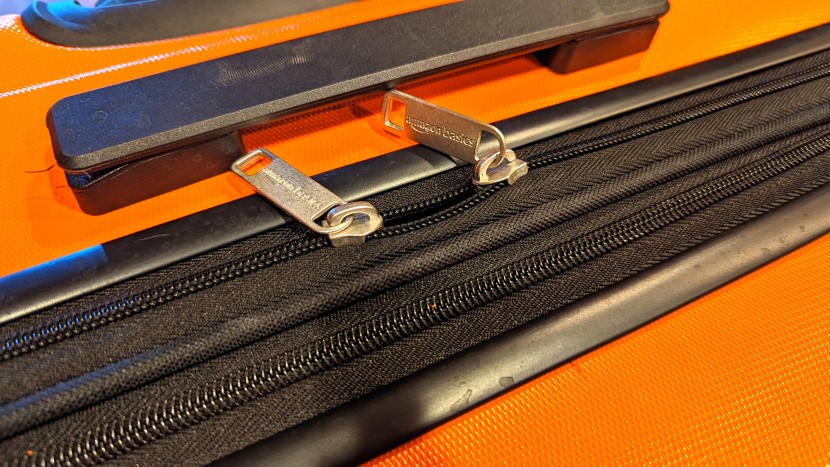 amazon basics 30&quot; hardside spinner - your fly&#039;s open. cheap zipper pulls and no loops to lock them...