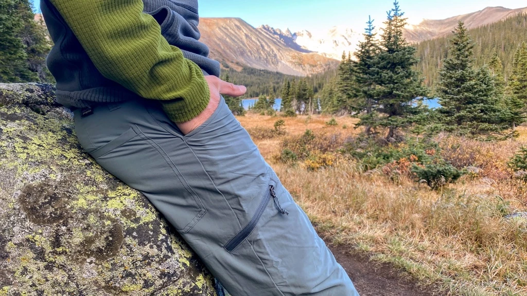 Hiker wearing quality hiking pants on mountain trail in fall weather
