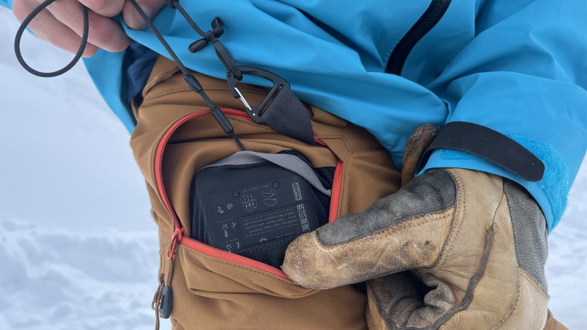 the right waist pocket has a transceiver clip and sleeve that keeps...