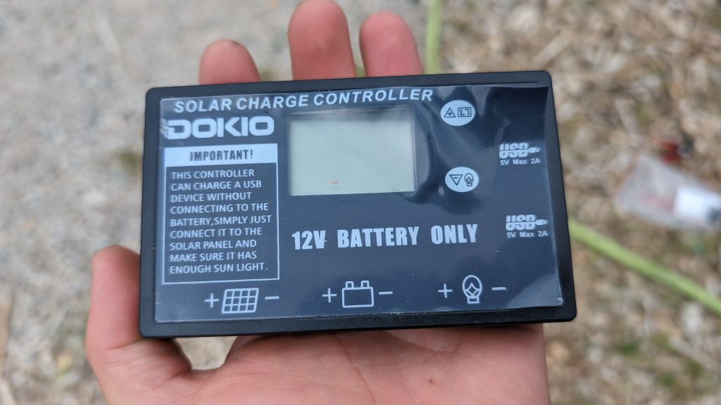 dokio 110w 18v portable kit - a close up on the charge controller with the cover already peeling...