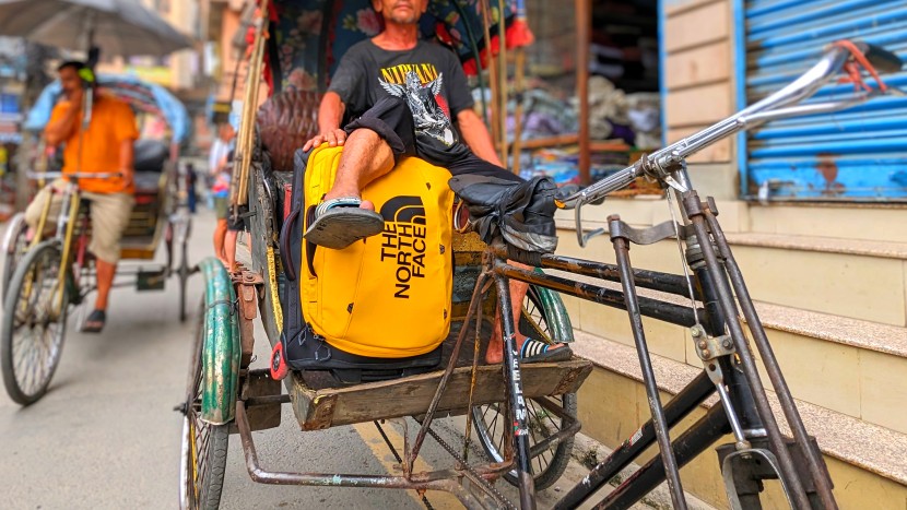carry on luggage - a nepalese rickshaw driver chillin&#039; with our the north face base...