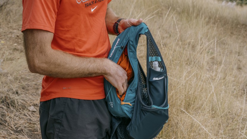 hydration pack for running men - larger pockets at the back of a vest pack are often used to carry...