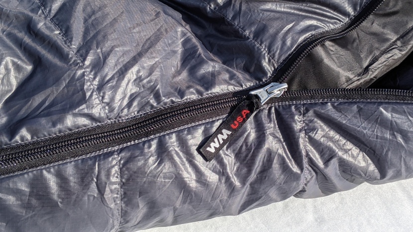 western mountaineering kodiak mf - the simple, old-school zipper runs along an inch of firm fabric tape...