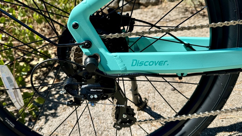 a shimano tourney 7-speed derailleur and kmc chain connect with a...