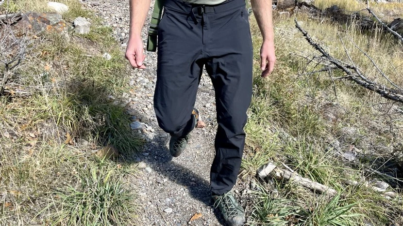 Hiker wearing Arc'teryx Gamma pants on mountain trail with proper fit and mobility