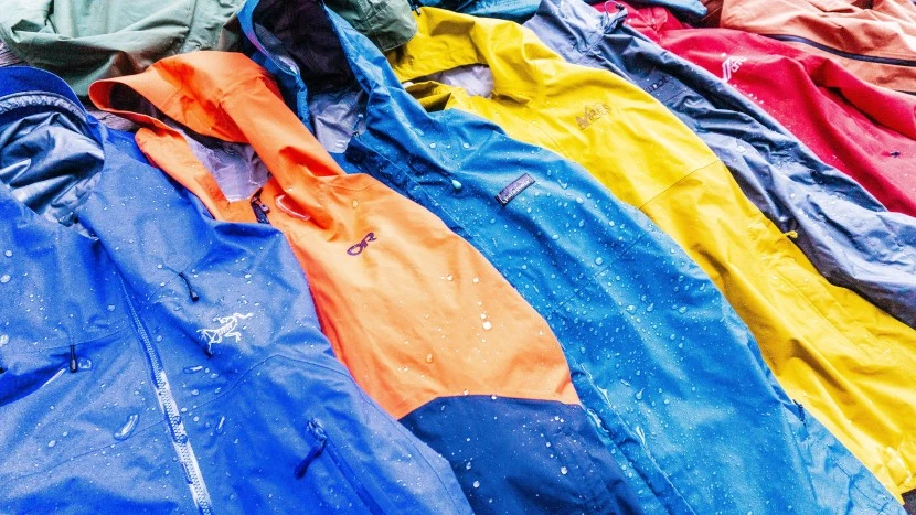 Premium waterproof rain jackets displayed showing different fabric technologies and construction methods