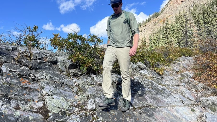 Professional outdoor gear testing - hiker in premium hiking pants on mountain trail
