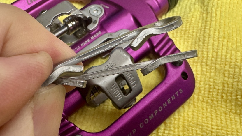 oneup clip pedals - old binding plates are on the bottom, and replacements are above.