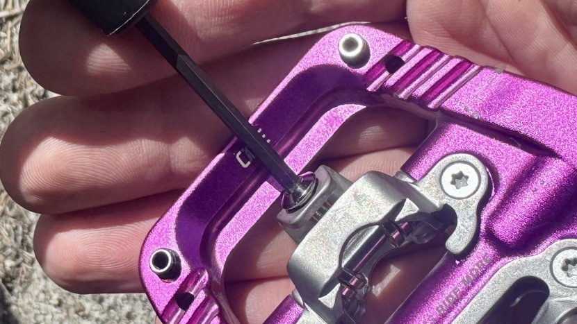 oneup clip pedals - similar to an spd adjustment, each side of the pedal uses a 3mm bolt...