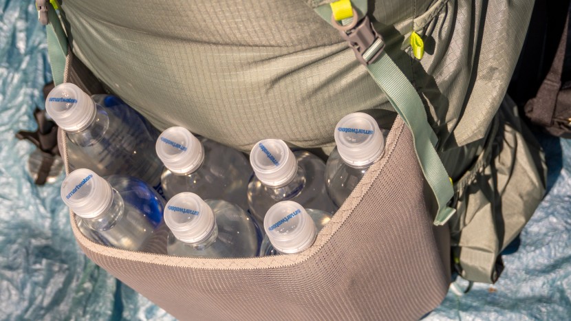 the center pocket can fit seven, 1l smartwater bottles if you decide...