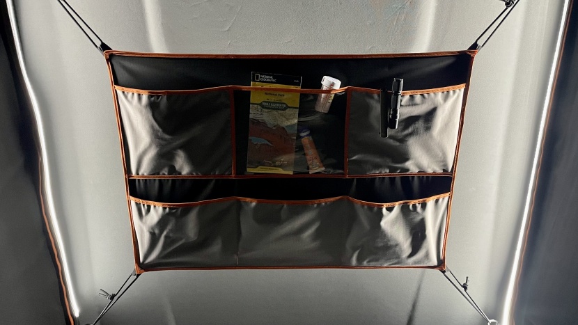 the main pocket organizer within the tent has a grid of pockets and...
