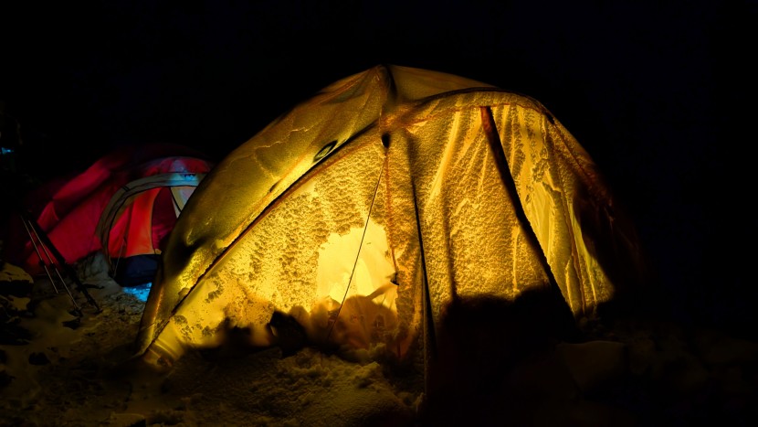 black diamond moji r+ - lighting our snow-covered tent early in the morning as we prepare to...