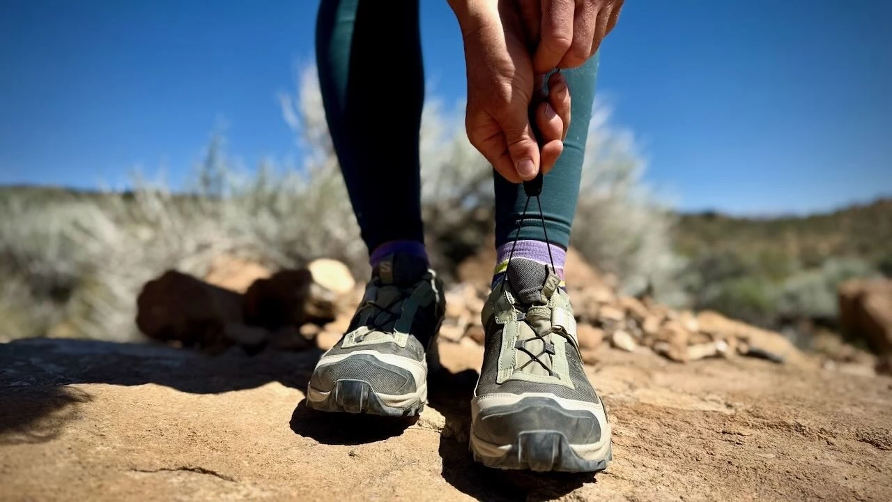 Detailed close-up of hiking shoe construction showing sole, upper materials, and lacing system