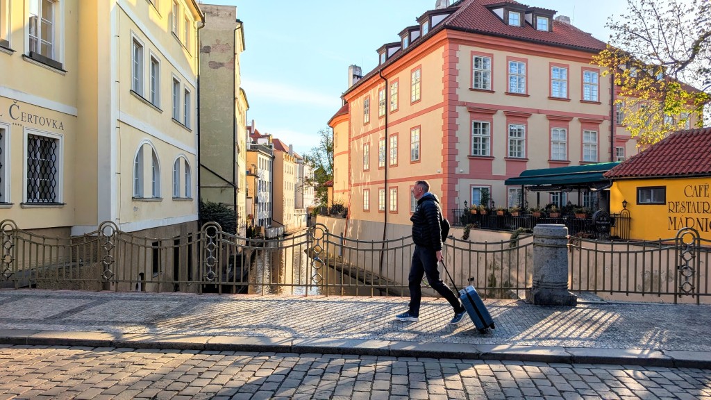 away the carry-on - cruising neighborhood cobblestone sidewalks in prague, czech republic.