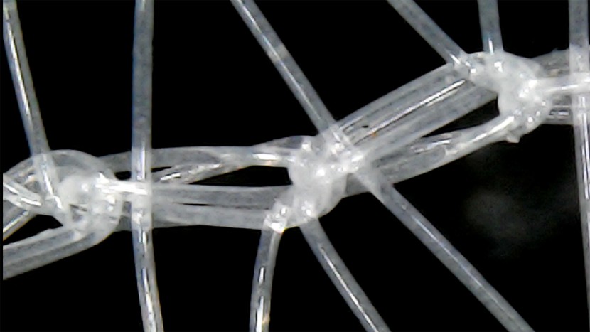 a closeup of the complicating knit of the loose white mesh material.